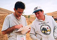 Chris Taylor explains his route choices on the Red course to A-meet director Scott Aster; Morgan Territory, October 2001 (Photo: Judy Koehler)