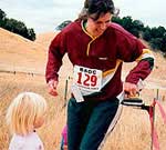 Janet punches the finish with the help of twin daughters Katie and Sarah; Morgan Territory A-meet, October 2001 (Photo: Judy Koehler)