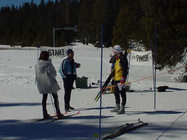 Yelena Krasnov (back facing us), course setter, talking with Vadim Masalkovas and Sergey Grushin at the start and finish area. Yelena finished first for women on the blue course at Royal Gorge.